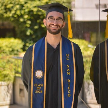 Keyan Azbijari in cap and gown at UC San Diego commencement.